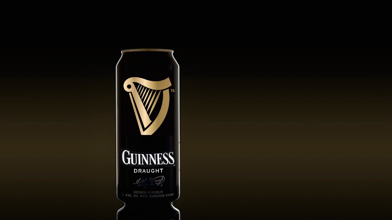 Close-up photo of a Guinness pint mid-pour, showing the cascading dark stout and creamy head forming