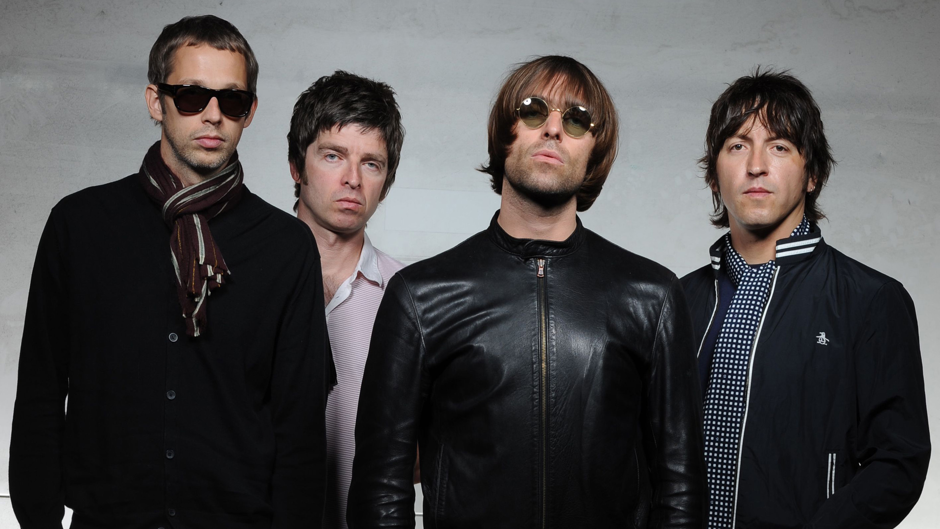Photo collage of Oasis-era Gallagher brothers alongside a screenshot of a Ticketmaster queue page